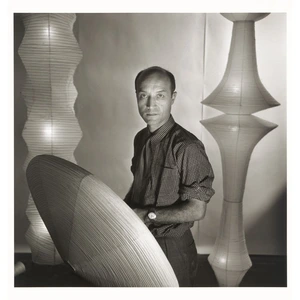 Isamu Noguchi crafting sculptural furniture in his studio