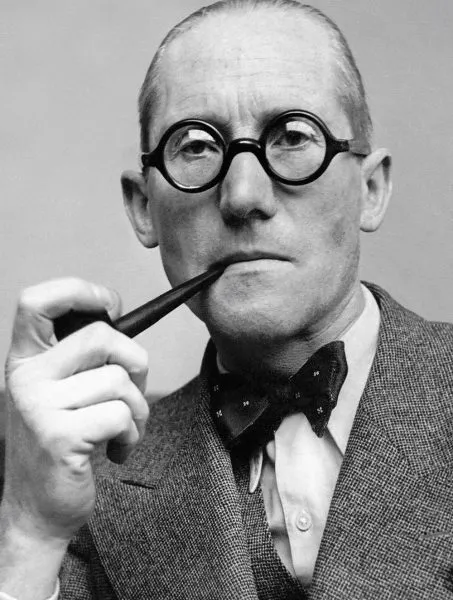 Le Corbusier inspecting architectural scale model