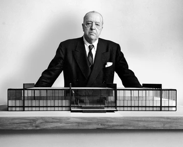 Ludwig Mies van der Rohe reviewing architectural plans at his studio desk